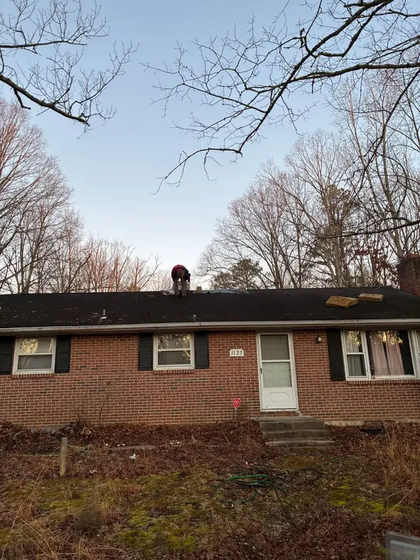 Brick ranch home with a completed dark asphalt shingle roof
