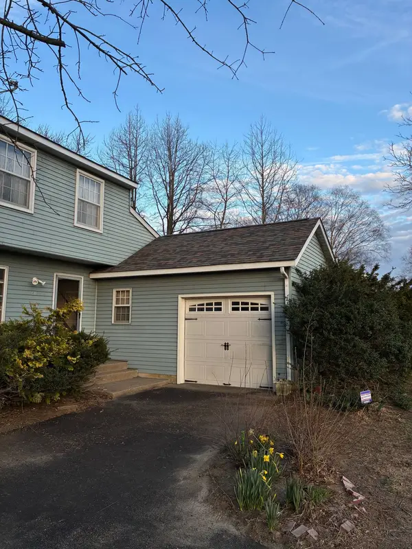 Blue garage with a completed gray asphalt shingle roof